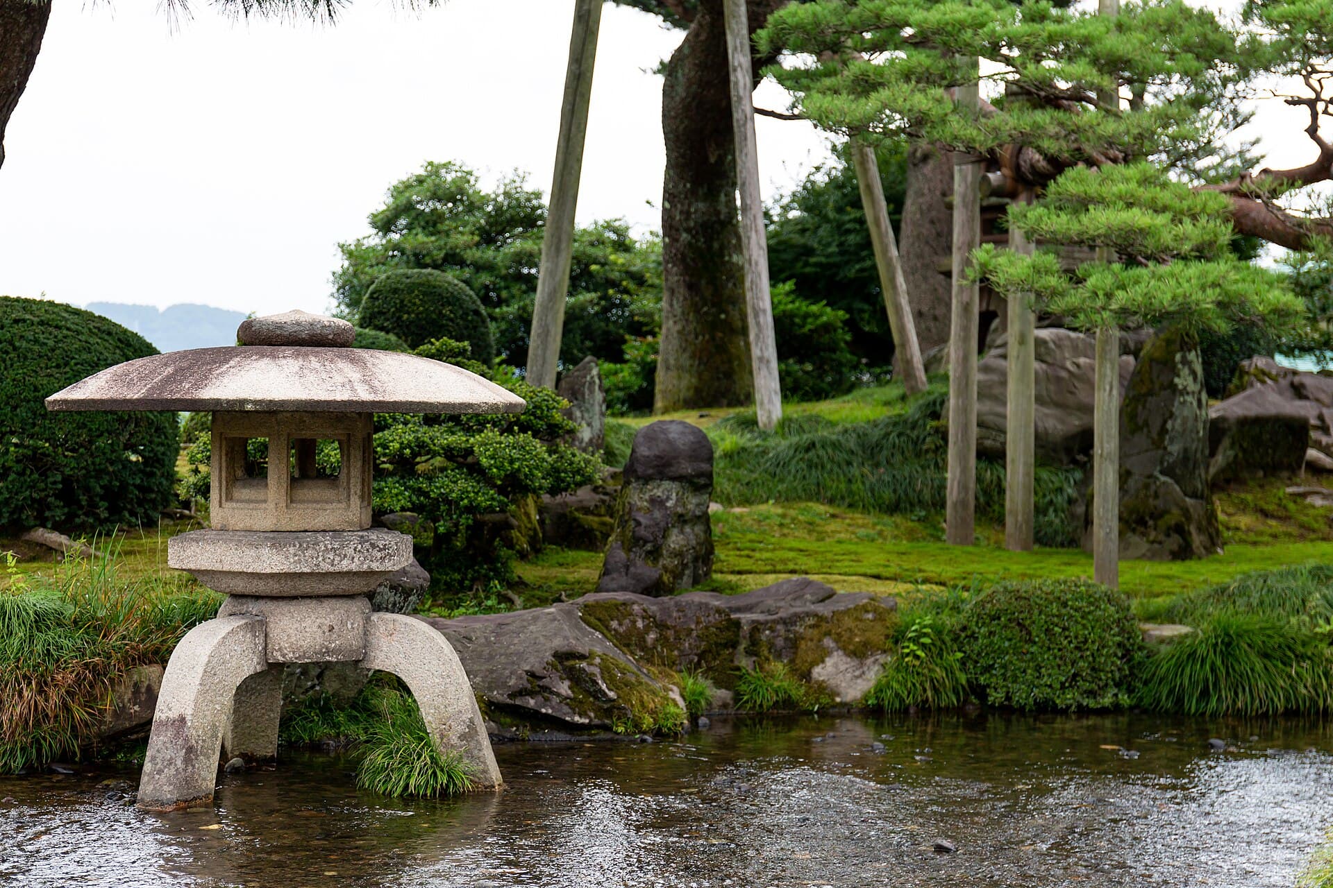 A path, water, and trees in Kenroku-en garden.