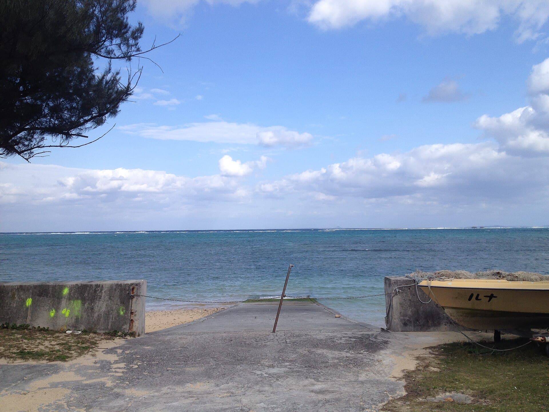 A sandy beach and blue water in Okinawa.