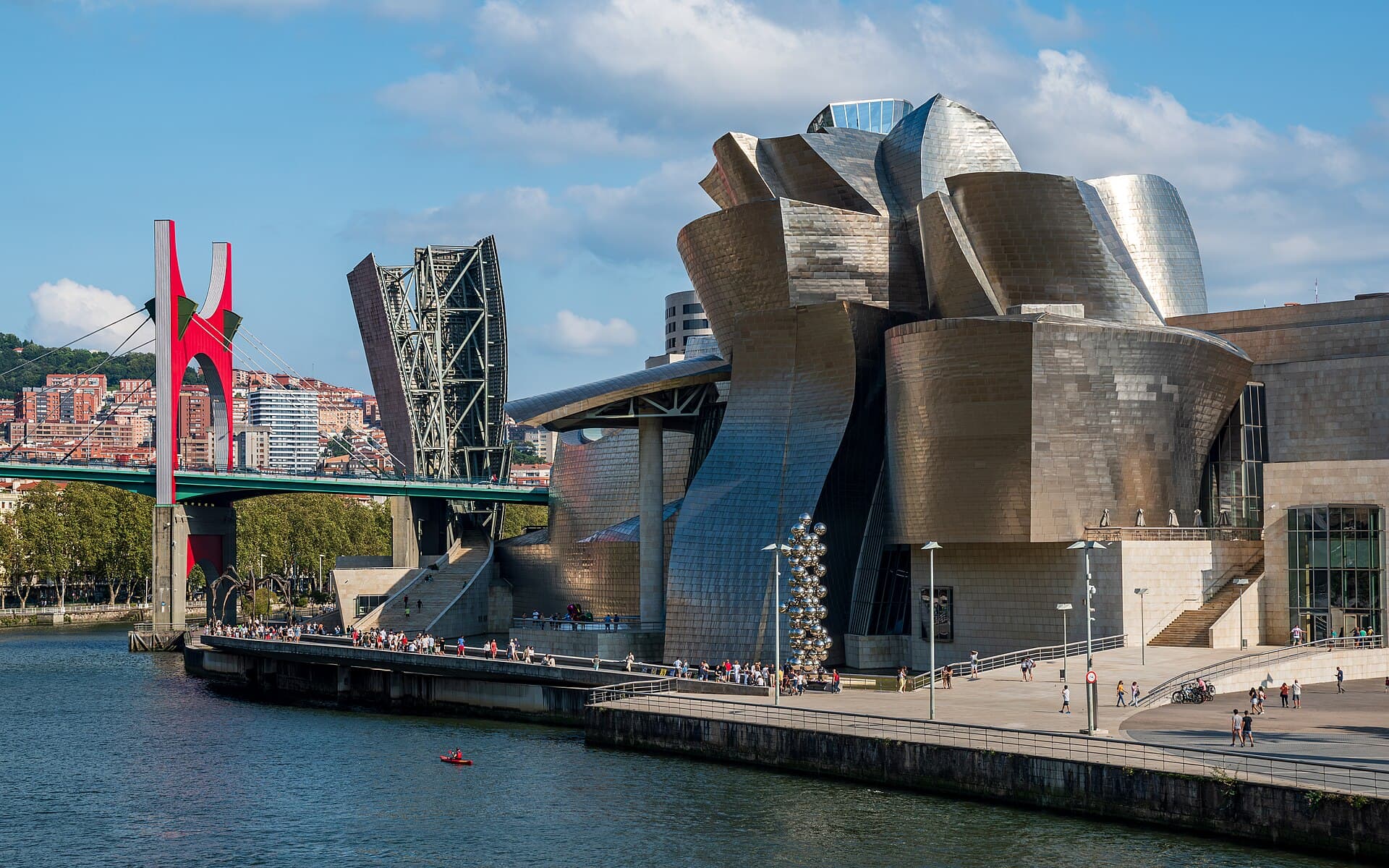 The Guggenheim Museum in Bilbao, curved metal surfaces beside the water.