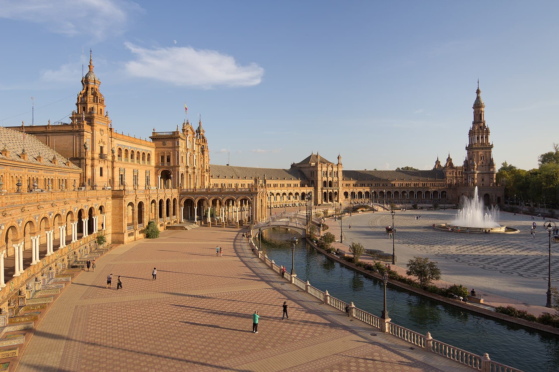 Plaza de España in Seville, a curved building with a canal in front and tiled benches.