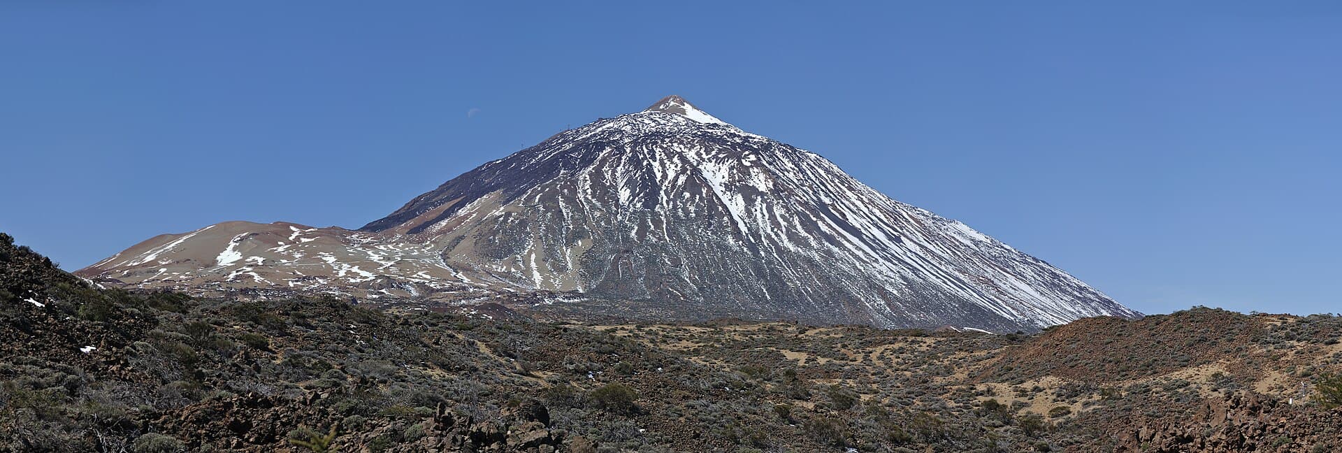 The summit of Teide on Tenerife, a volcanic cone above a field of lava.