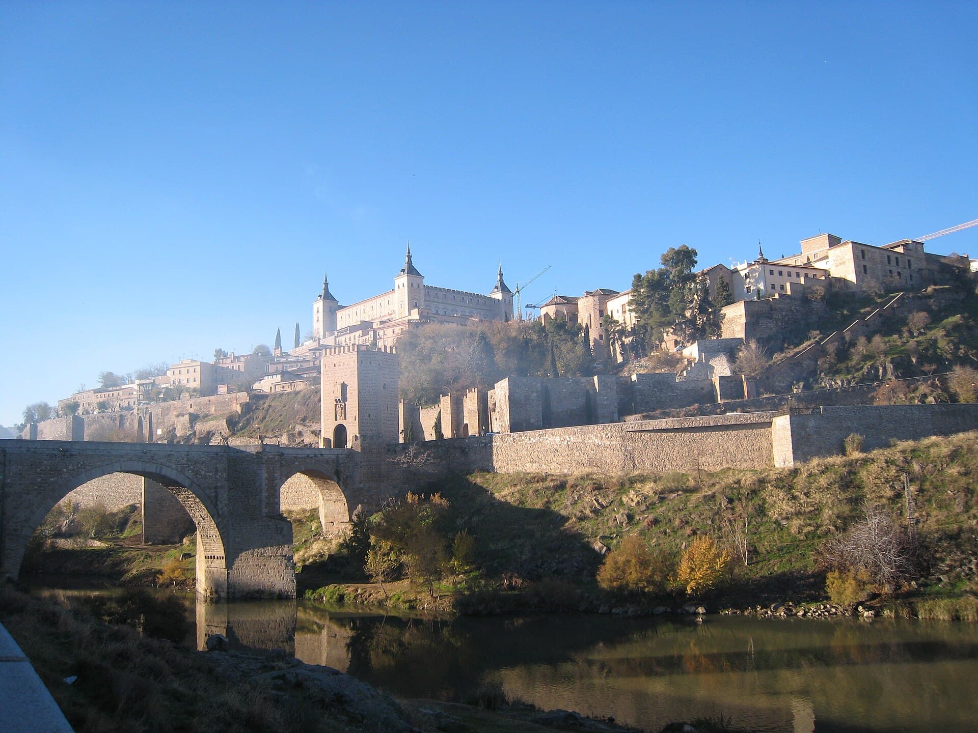 Toledo gathered on a hill inside a river bend, walls above the rock.