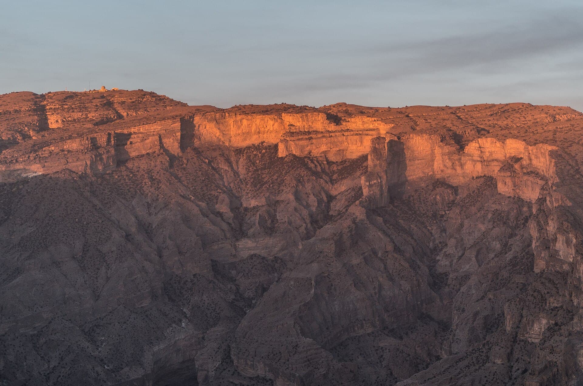 The rock walls of Wadi Nakhur below Jebel Shams at sunset.