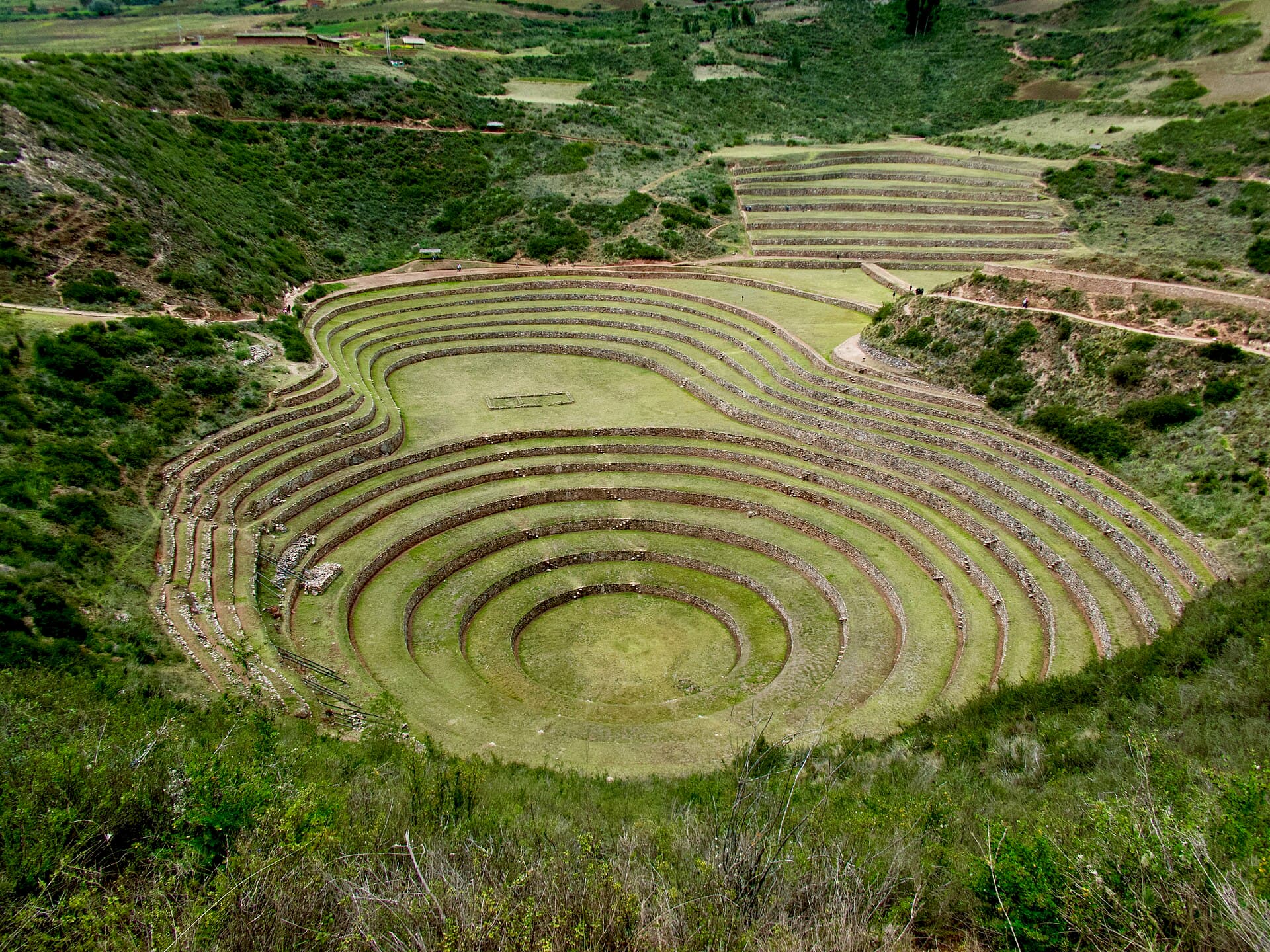 The concentric circular terraces of Moray stepping down into a green hollow.
